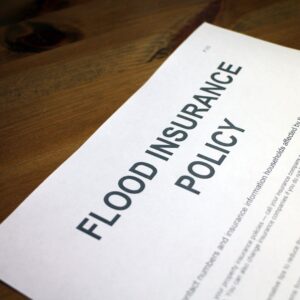 Piece of paper that says "flood insurance policy."